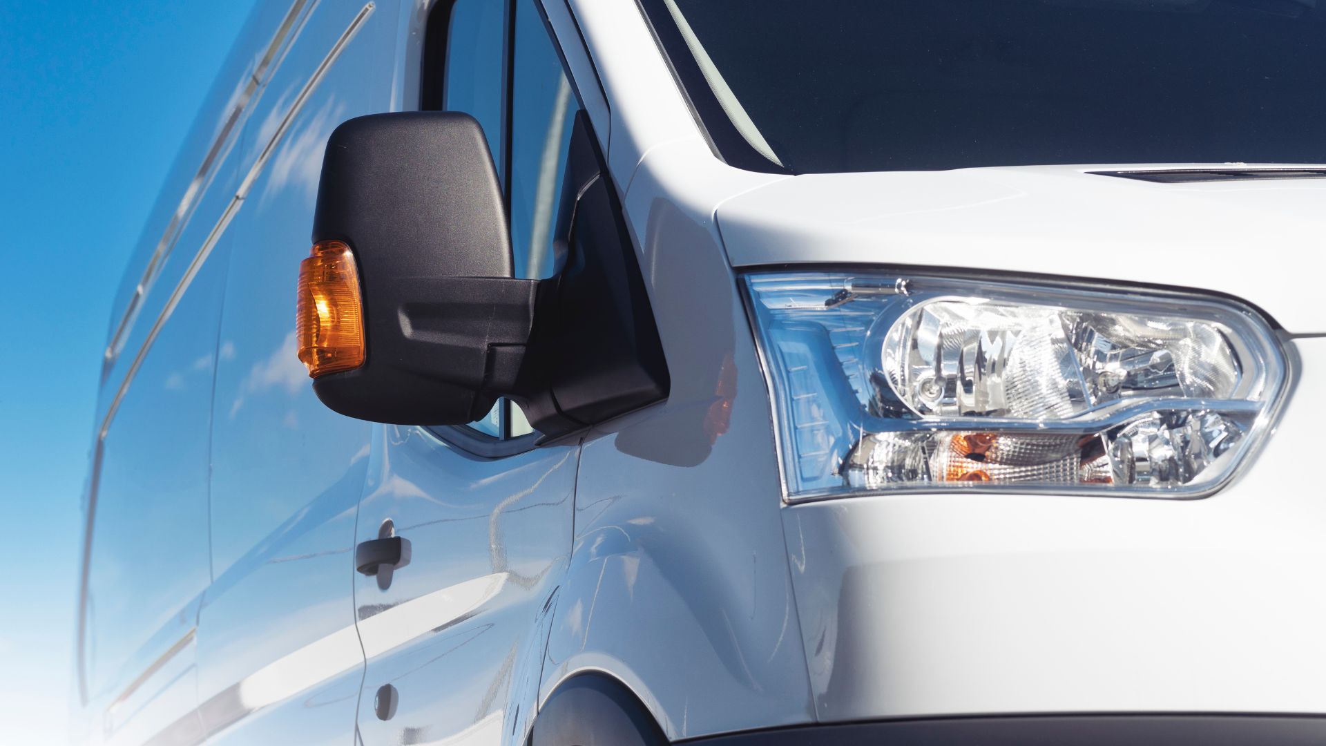 A close up of a van with its lights on