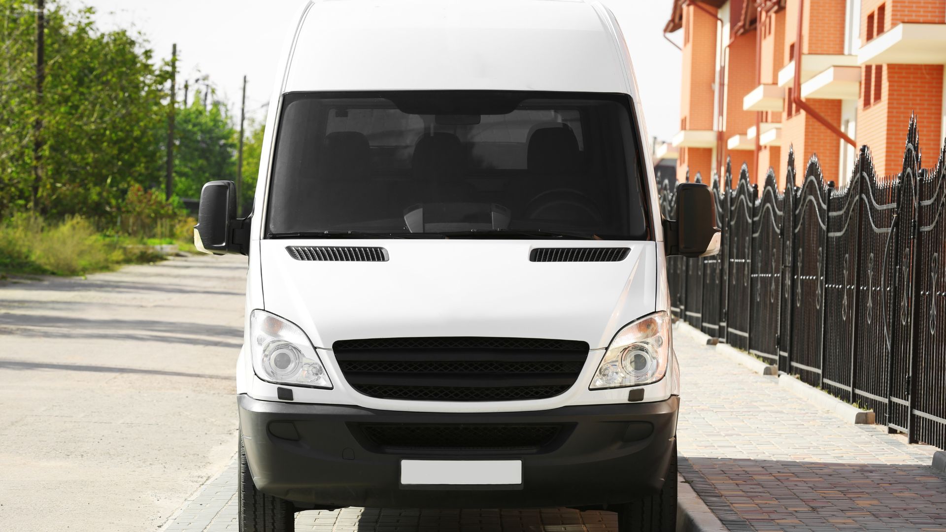 A white van parked on the side of a road