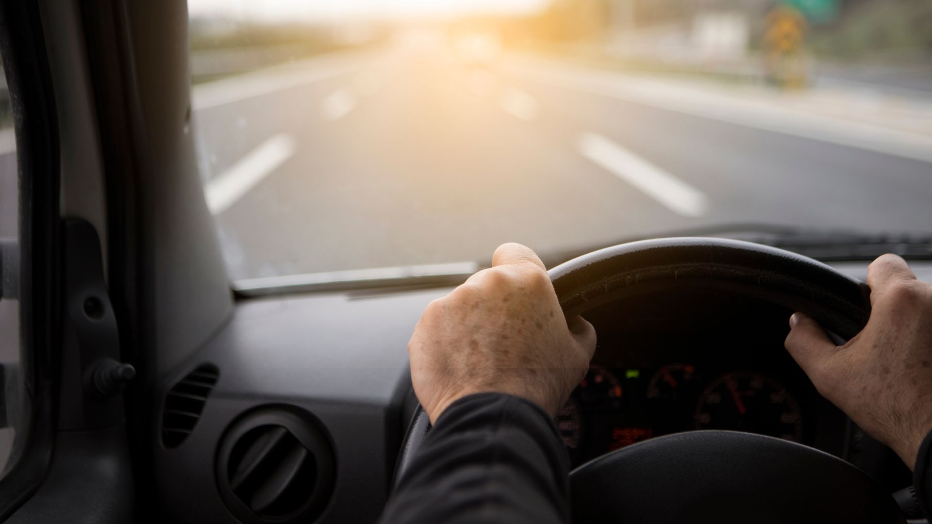 A person driving a car on a highway